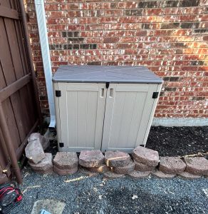Outdoor equipment shed for protecting water softener or filtration system in DFW backyard — durable weather protection with easy service access.